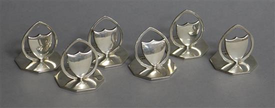 A set of six Edwardian silver menu holders with shield motifs, Horace Woodward & Co Ltd, Birmingham, 1907, base 32mm.